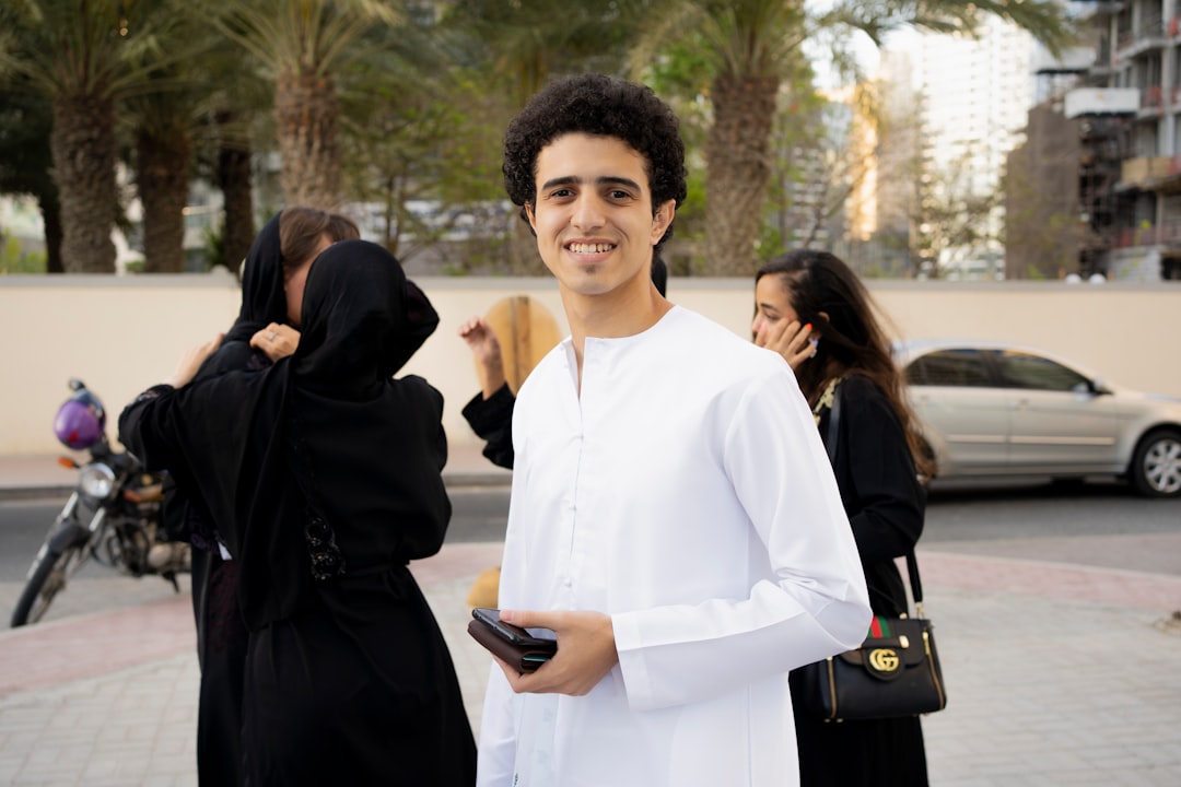 International student preparing documents to submit Dubai university application at a modern campus desk with a laptop